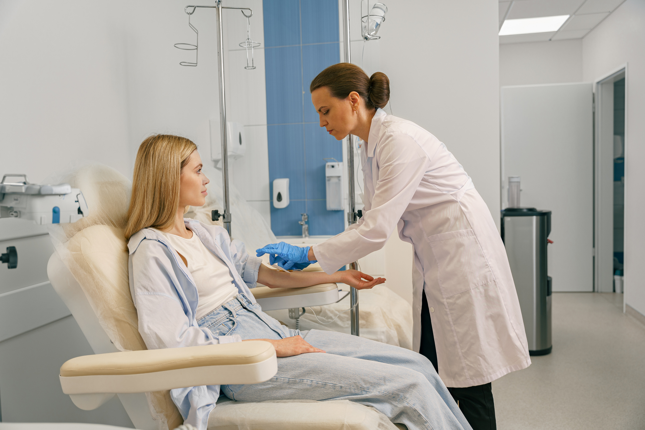 a female doctor is passing canula to a patient