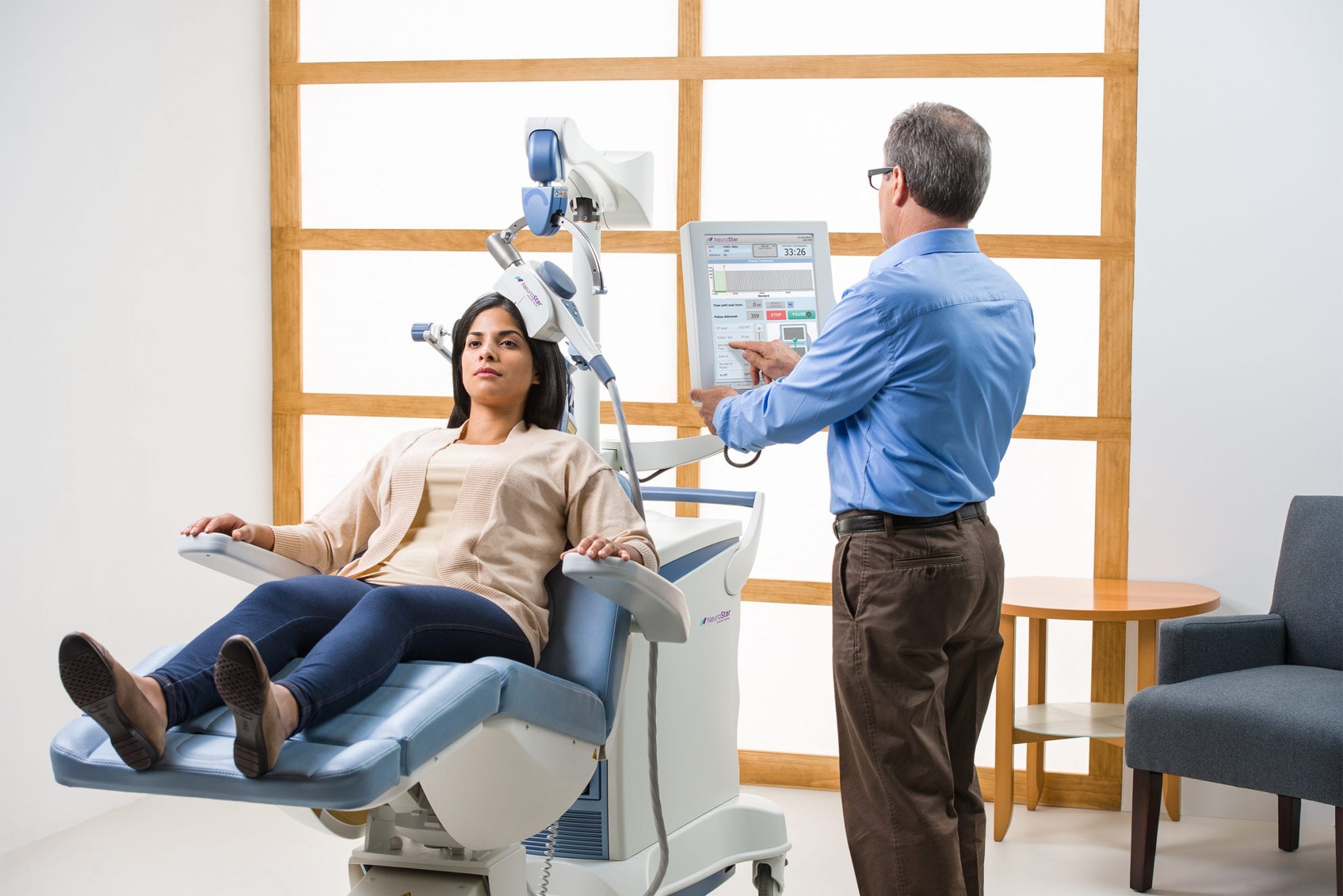 a doctor is performing a e.e.g test of a lady